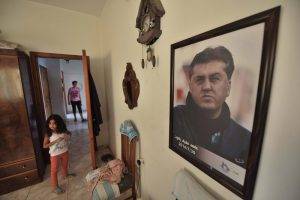 A poster of Ahed Zaqout is displayed in the apartment rented by his surviving family.